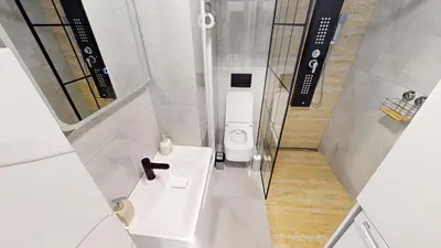 a small bathroom with a white toilet and a sink at Luka in Belgrade