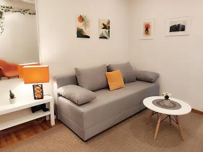 a living room with a couch and a table at Center Obi-One in Belgrade