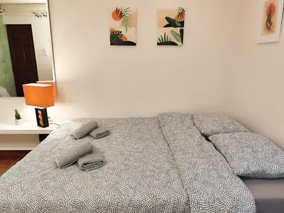 a bedroom with a bed with two towels on it at Center Obi-One in Belgrade