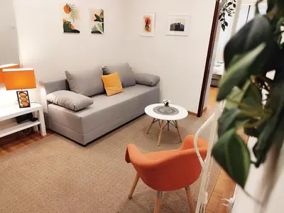 a living room with a couch and a table at Center Obi-One in Belgrade