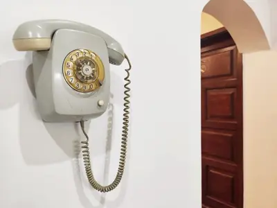 a telephone hanging on a wall next to a door at Center Obi-One in Belgrade
