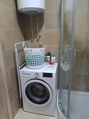 a washing machine with a basket on top of it at Apartman Ana in Kumodraž