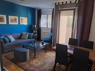 a living room with a couch and a table at Apartman Ana in Kumodraž