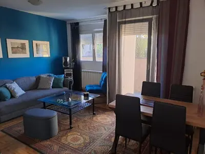 a living room with a couch and a table at Apartman Ana in Kumodraž