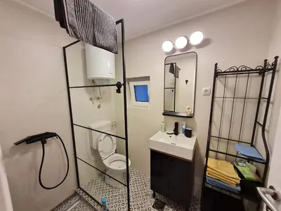 a bathroom with a toilet and a sink and a mirror at Mansarda, Belgrade in Belgrade