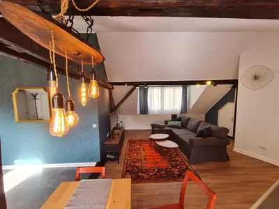 a living room with a couch and a table at Mansarda, Belgrade in Belgrade