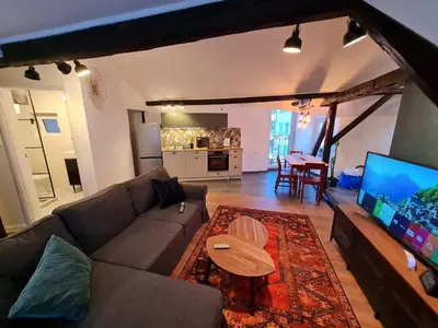 a living room with a couch and a flat screen tv at Mansarda, Belgrade in Belgrade