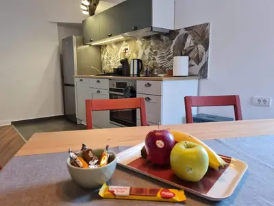 a table with a plate of fruit and a bowl of apples at Mansarda, Belgrade in Belgrade