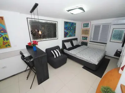 a living room with a bed and a couch at Galerija MARSHAL in Belgrade