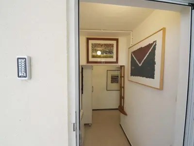 a hallway with a door and paintings on the wall at Galerija MARSHAL in Belgrade