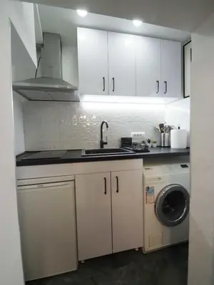 a kitchen with a sink and a washing machine at Galerija MARSHAL in Belgrade