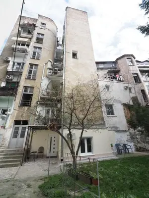 an apartment building with a tree in front of it at Galerija MARSHAL in Belgrade