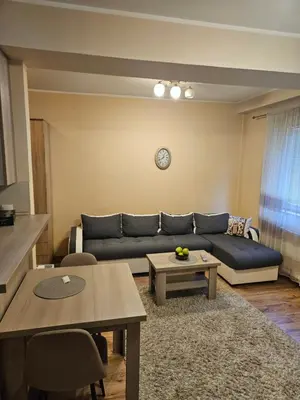 a living room with a couch and a table at Relax 2, sa parkingom in Obrenovac