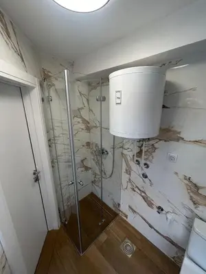 a bathroom with a glass shower with a ceiling at Kosancic No.1 in Belgrade