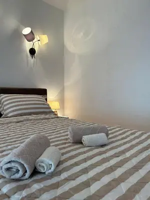 a bed with two towels on top of it at Kosancic No.1 in Belgrade