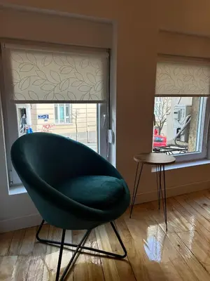 a green chair sitting in front of a window at Kosancic No.1 in Belgrade