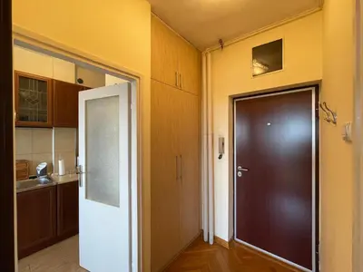 a kitchen with a door leading to a kitchen with a sink at Vintage Delight Apartment Vracar Hram Sv Save in Belgrade