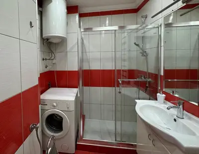 a bathroom with a washing machine and a sink at Vintage Delight Apartment Vracar Hram Sv Save in Belgrade