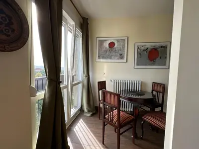 a dining room with a table and chairs and a window at Vintage Delight Apartment Vracar Hram Sv Save in Belgrade