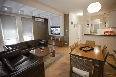 a living room with a couch and a table at Vip apartment Beograd in Belgrade