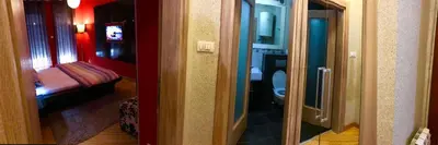 a room with a bathroom with a toilet and a bedroom at Vip apartment Beograd in Belgrade