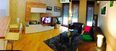 a living room with a couch and a television at Vip apartment Beograd in Belgrade