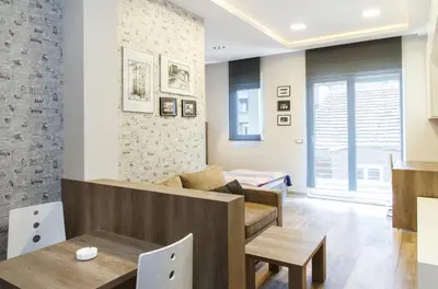 a living room with a couch and a table at Apartment Barcelona in Belgrade