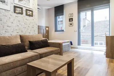 a living room with a couch and a table at Apartment Barcelona in Belgrade