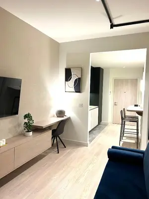 a living room with a couch and a table and a tv at Belgrade Waterfront- Libera in Belgrade