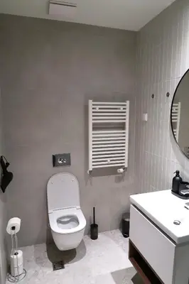 a bathroom with a toilet and a sink and a mirror at Belgrade Waterfront- Libera in Belgrade