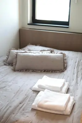 three white towels sitting on top of a bed at Belgrade Waterfront- Libera in Belgrade