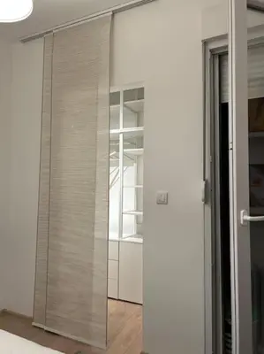 a sliding glass door to a closet in a room at Apartment Fiore in Smederevo