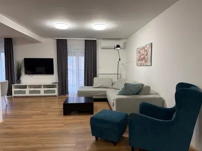 a living room with a couch and chairs and a tv at Deluxe apartment Magnolia 2 in Belgrade