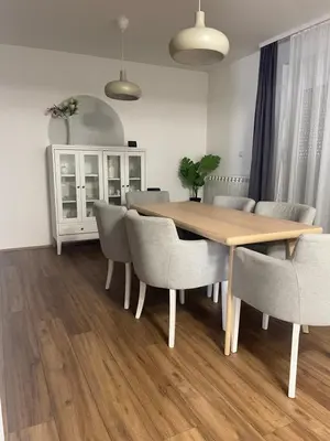 a dining room with a wooden table and chairs at Deluxe apartment Magnolia 2 in Belgrade