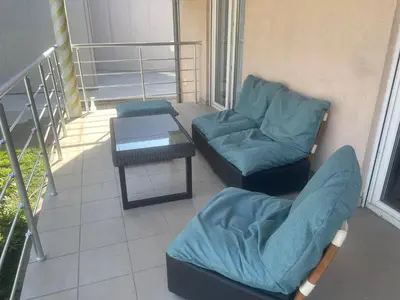 a balcony with two chairs and a table on a building at Deluxe apartment Magnolia 2 in Belgrade