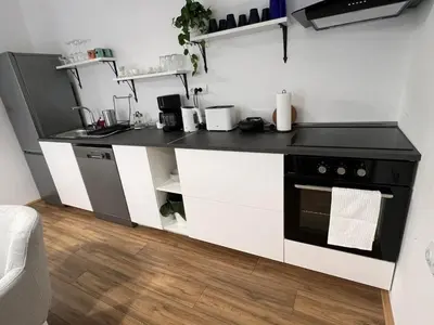 a kitchen with a black and white counter top at Deluxe apartment Magnolia 2 in Belgrade