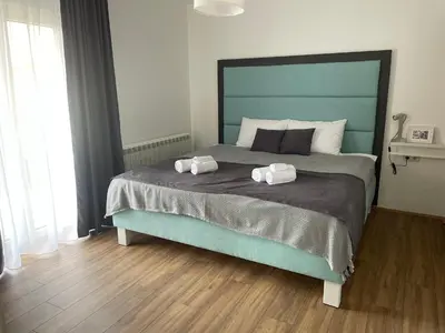 a bedroom with a large bed with two towels on it at Deluxe apartment Magnolia 2 in Belgrade