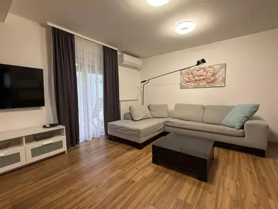 a living room with a couch and a flat screen tv at Deluxe apartment Magnolia 2 in Belgrade