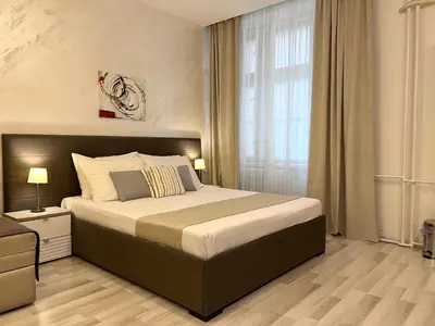 a bedroom with a large bed and a window at Centar Forever in Belgrade