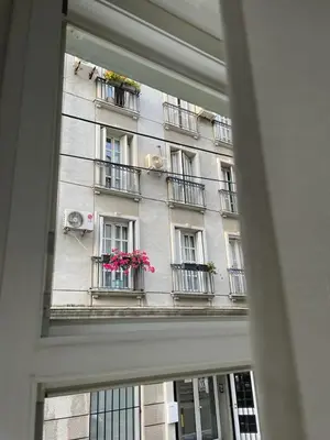 a window view of a building with flowers on the balconies at City Apartments Ana in Belgrade