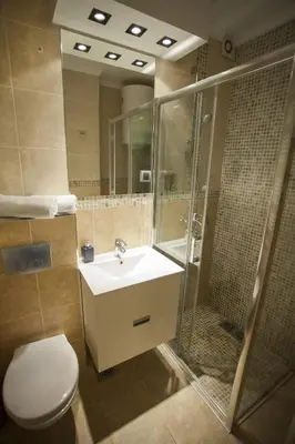 a bathroom with a toilet and a sink and a shower at Apartment Red in Belgrade