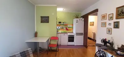 a kitchen with a white refrigerator and a table and chairs at Blossom in Belgrade