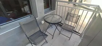 a balcony with two chairs and a table on a porch at Blossom in Belgrade