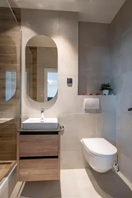 a bathroom with a sink and a toilet and a mirror at Sinfonia Lux 1205 in Sajmište