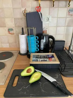 a cutting board with an avocado and a knife on a counter at LUX Apartment in Belgrade, Centre in Belgrade