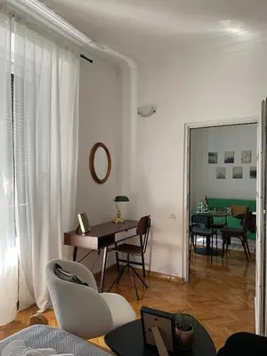a living room with a table and chairs and a dining room at LUX Apartment in Belgrade, Centre in Belgrade