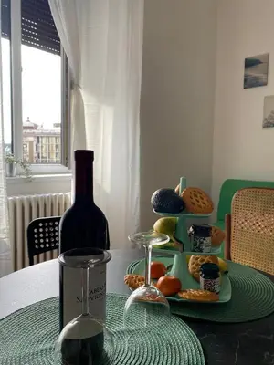 a table with a bottle of wine and a plate of food at LUX Apartment in Belgrade, Centre in Belgrade