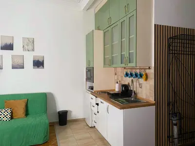 a kitchen with a sink and a green couch in it at LUX Apartment in Belgrade, Centre in Belgrade