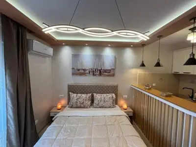 a bedroom with a large bed with two lights on it at ANDREA in Mali Mokri Lug