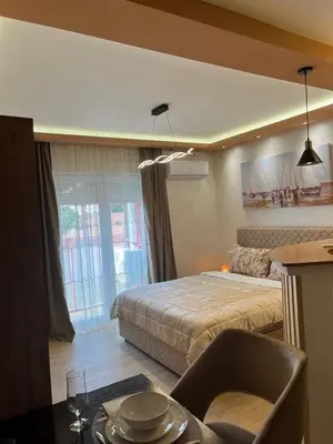 a bedroom with a bed and a table with a chair at ANDREA in Mali Mokri Lug